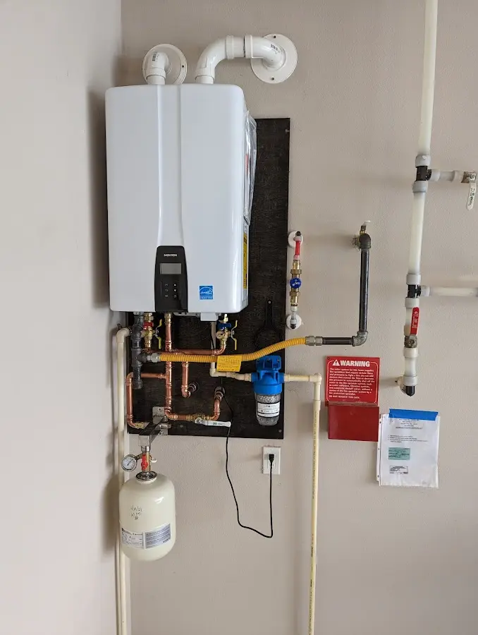 Professional plumber installing copper piping in a Prospect home